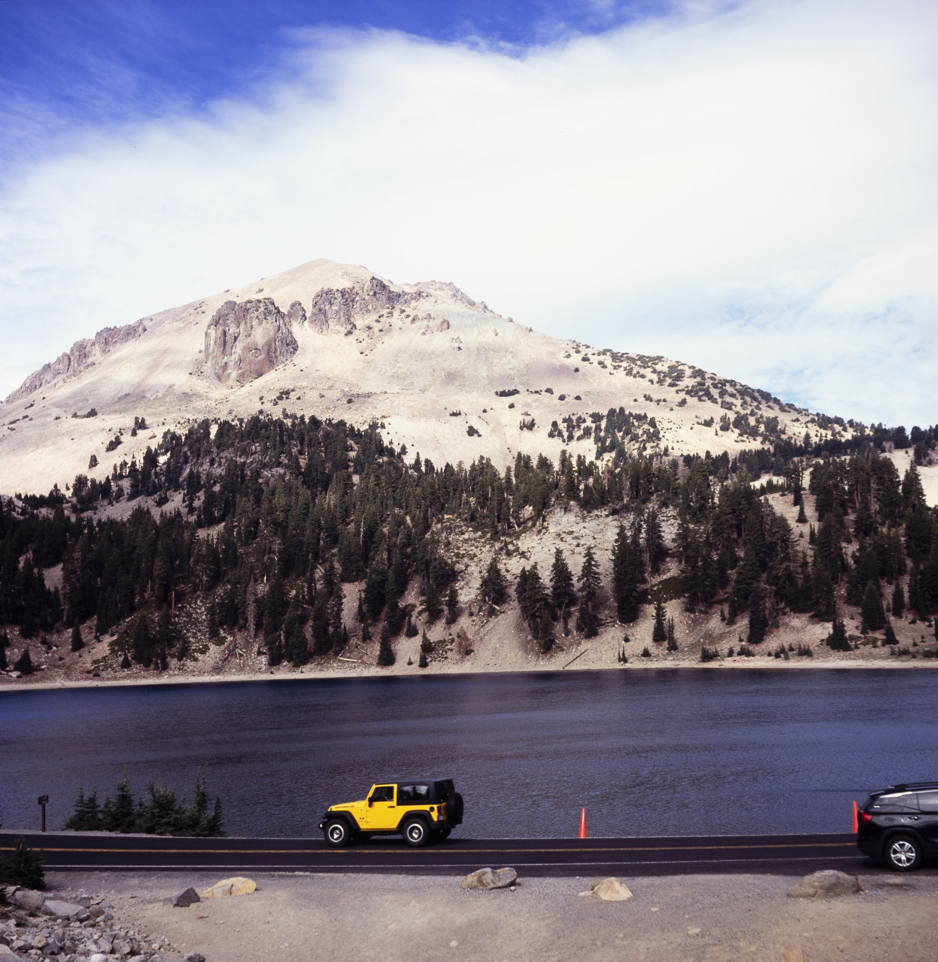 Interestingly enough, the pull outs by Lake Helen are actually <em>closer</em> to Bumpass Hell than the full Bumpass Hell parking lot. Of course, a parking lot is a nicer spot for a vehicle. Note Mt. Lassen in the background, looking resplendent with ´Vulcan's Eye´ prominent.