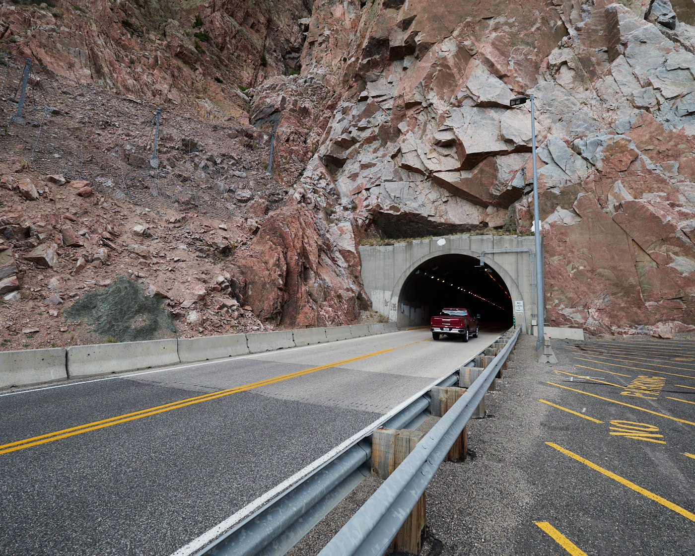 A pickup truck makes its way into the Cody Mountain Tunnel on US Highway 14/16/20